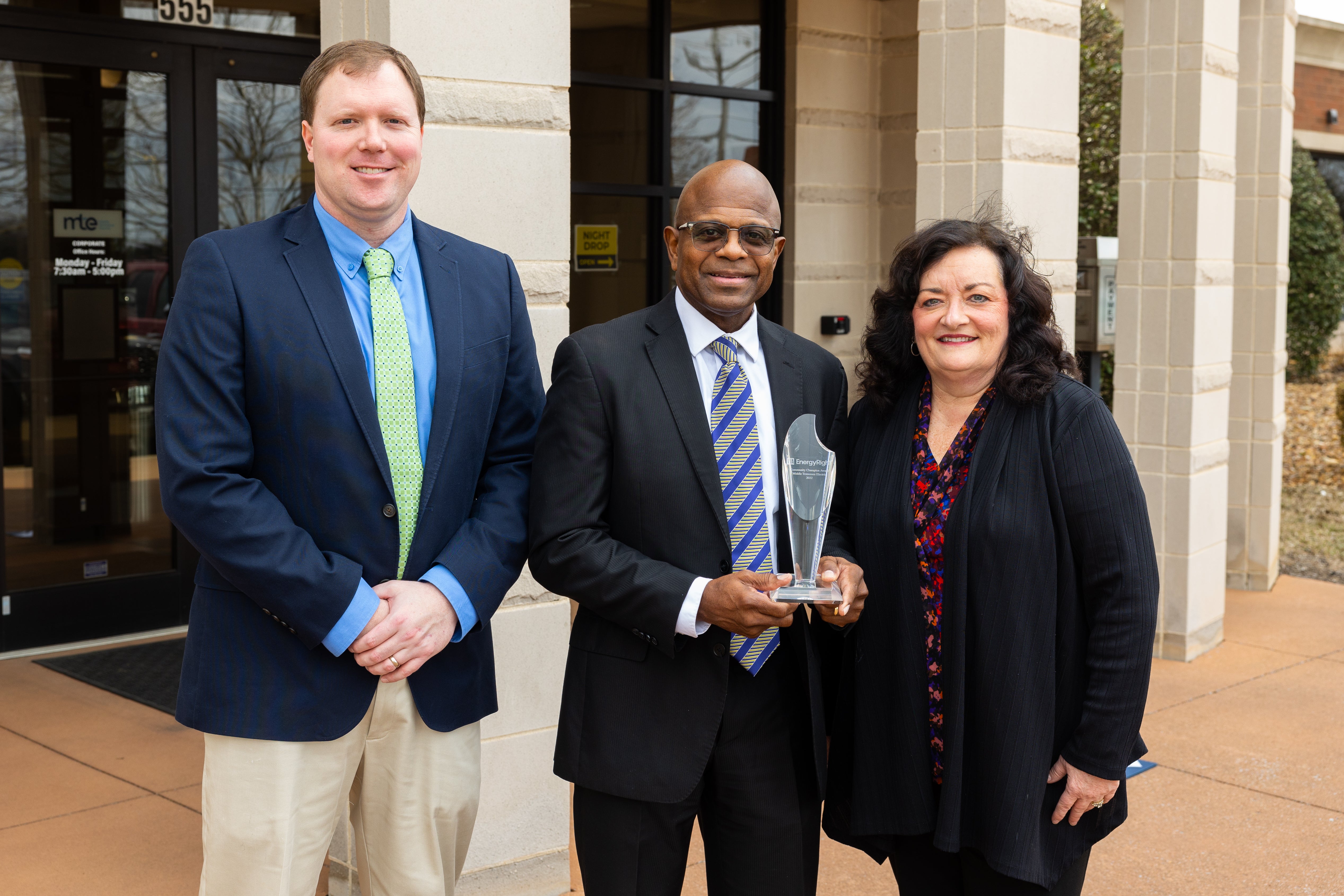 MTE team members accept the award from TVA's Cindy Herron