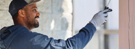 mte lineman Chris Miller painting during Co-Op Days of Service