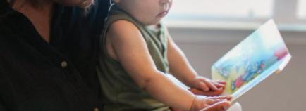 woman reading book to a child